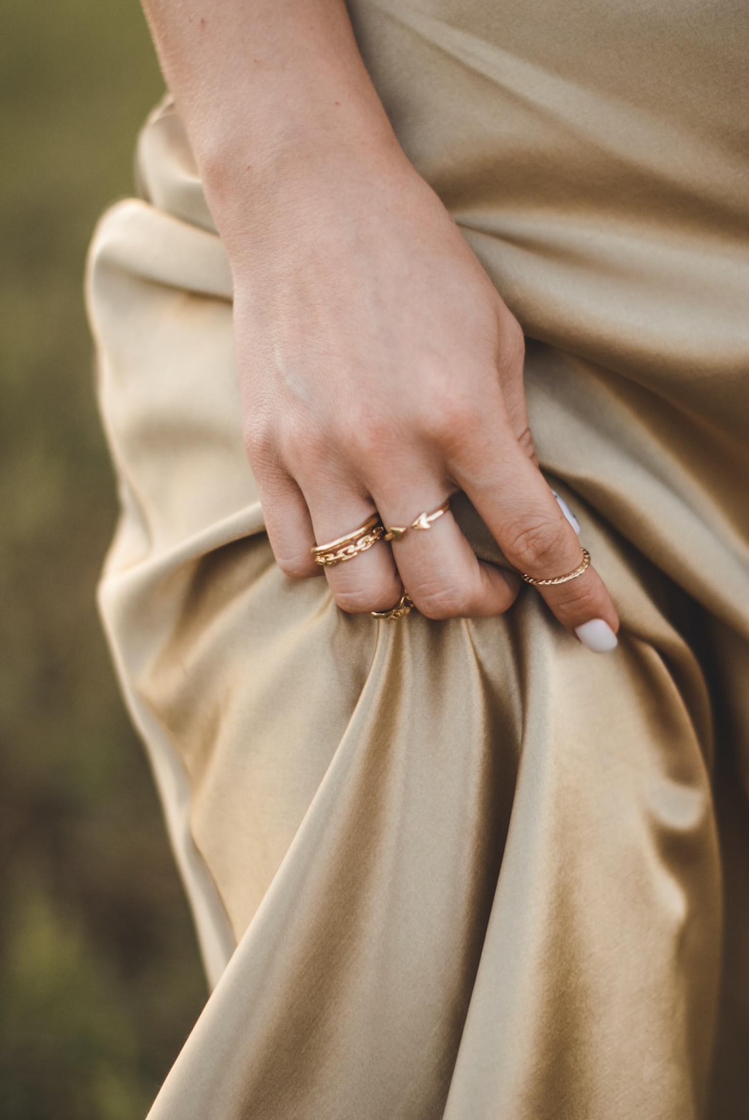 hand with ring holding dress
